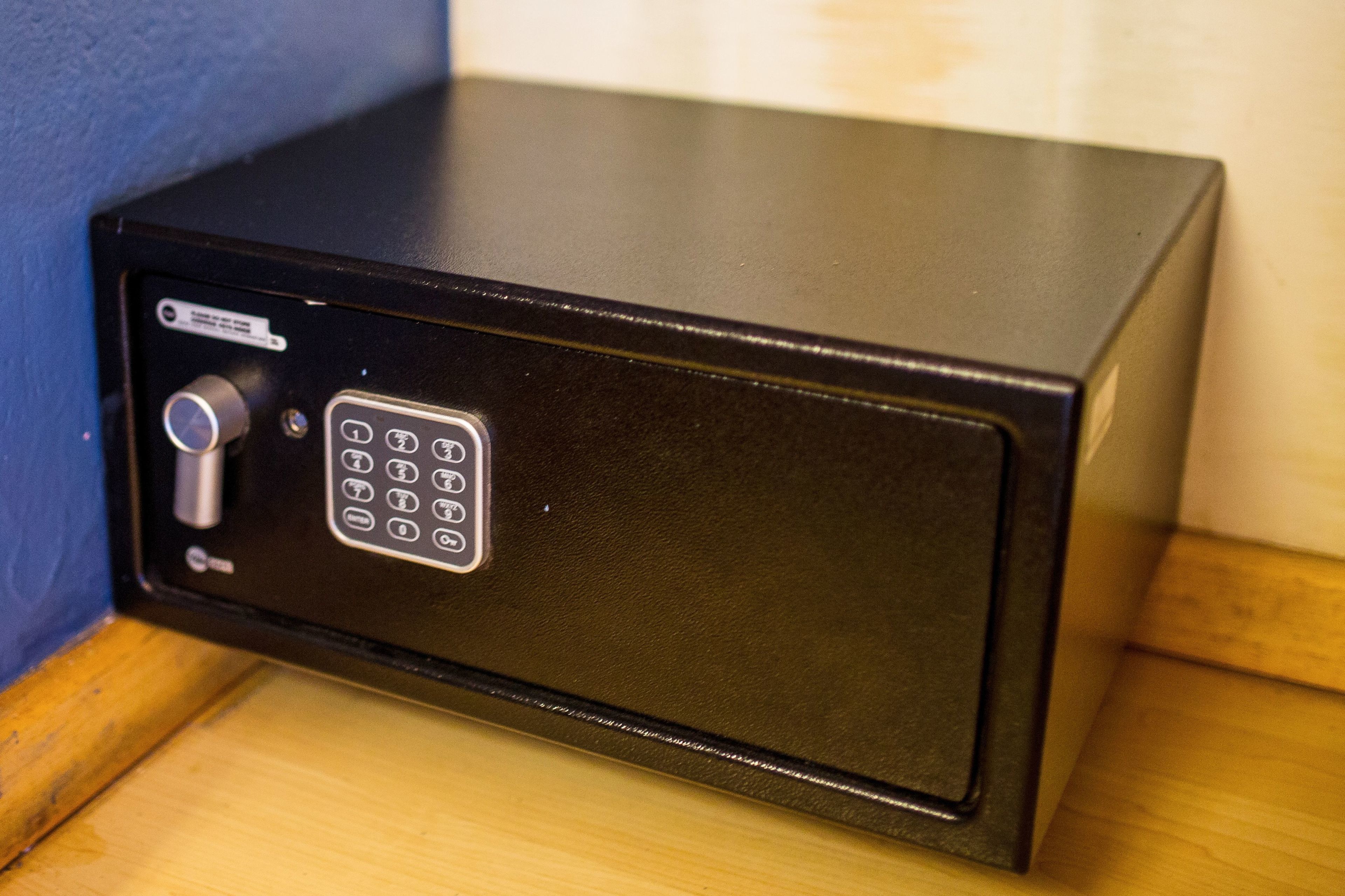 A black safe with a keypad and a combination lock.