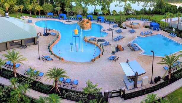A large outdoor swimming pool with multiple water features and lounge areas. - Wyndham Garden Lake Buena Vista – Disney Springs® Area (Lake Buena Vista)