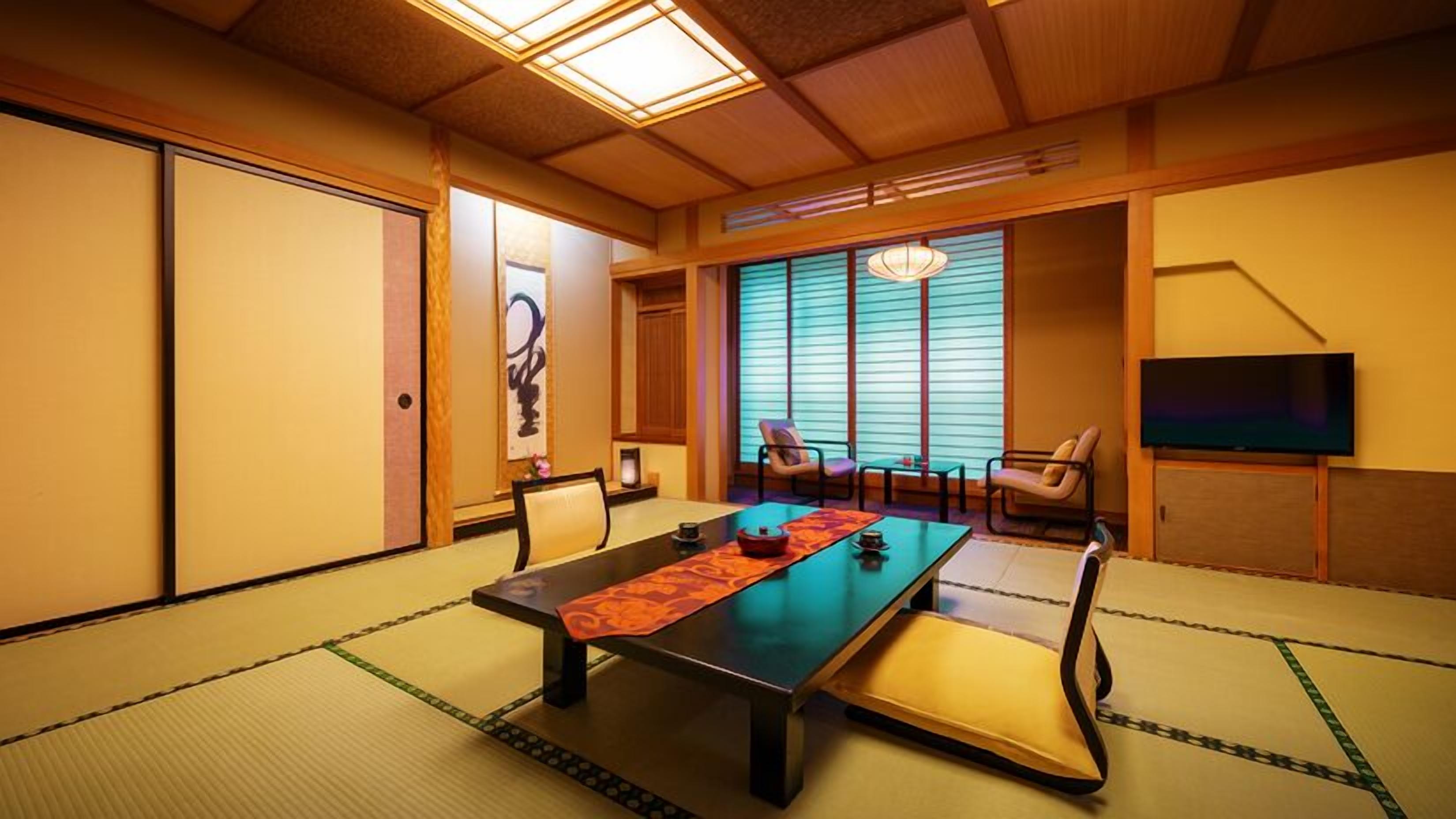 A traditional Japanese-style room with tatami flooring, a low table, and sliding doors.