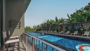 A swimming pool with a tiled edge, sun loungers, and a metal railing. - Sugar Marina Hotel - AVIATOR - Phuket Airport (Sa Khu)