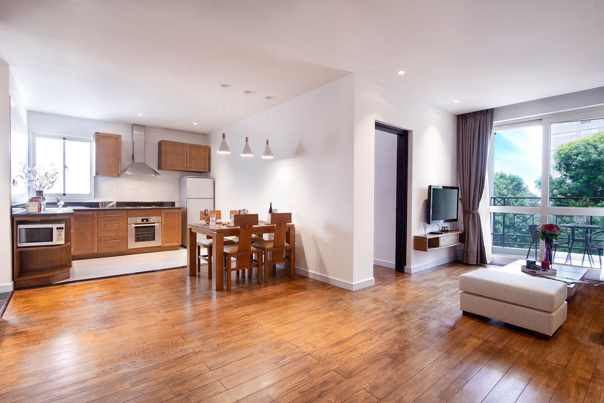 A modern apartment with a kitchen, dining area, and living room.