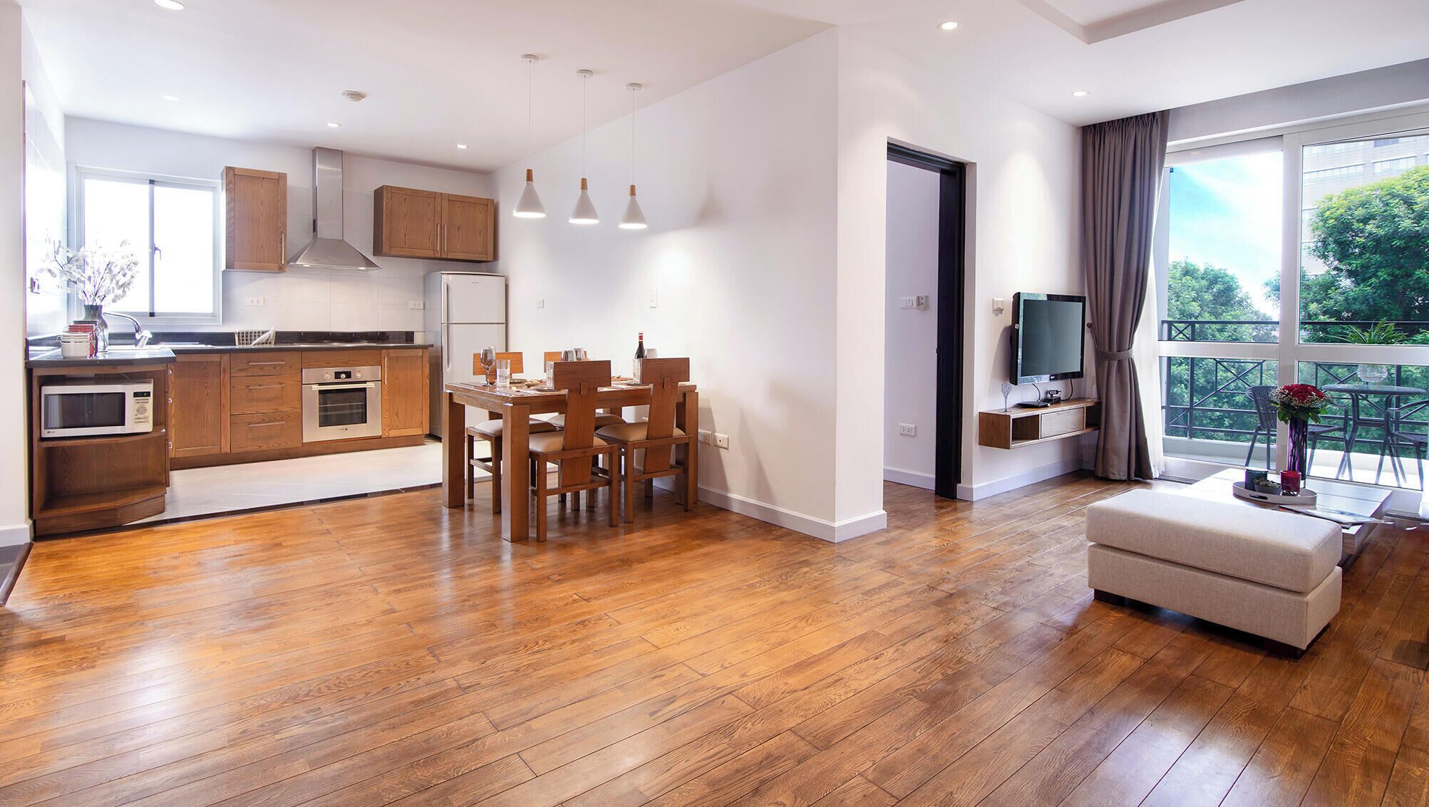A modern apartment with a kitchen, dining area, and living room.