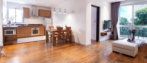 A modern apartment with a kitchen, dining area, and living room.