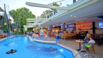 Relax by the pool, where guests can swim laps or socialize at the adjacent tables and chairs.