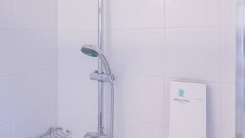 A modern shower with a rain showerhead, handheld showerhead, and a control panel.