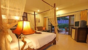 A four-poster bed with a canopy, a television, and a minibar in a hotel room. - Napalai Pool Villa Resort (Pattaya)