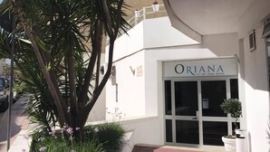 A hotel entrance with a sign reading "ORIANA AT THE TOPAZ HOTEL". - Oriana Hotel (St. Paul's Bay)