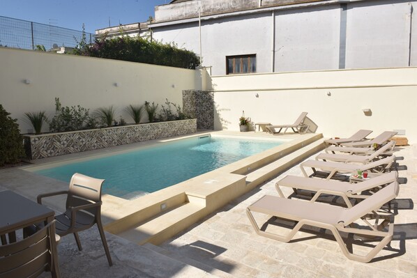 Seasonal outdoor pool, open 9:00 AM to 7:00 PM, pool umbrellas