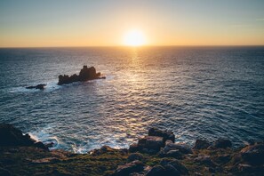 A coastal scene with a rocky outcrop and the ocean. - The Land's End Hotel (Penzance)