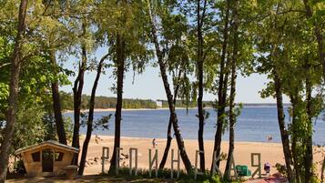 Escape to a serene lakeside haven with breathtaking views of the water and surrounding trees.