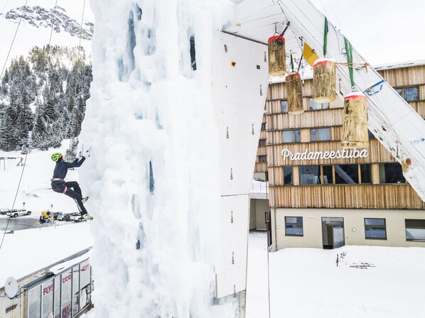 A building with a wooden facade and the name 'Pradaneestiba' visible. - JUFA Hotel Malbun (Triesenberg)