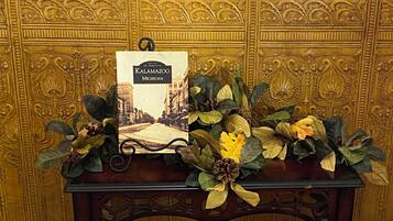 A table with a book titled 'Kalamazoo Michigan' and decorative foliage.