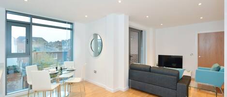 Deluxe Apartment, 1 Bedroom, Balcony | Living area | Flat-screen TV