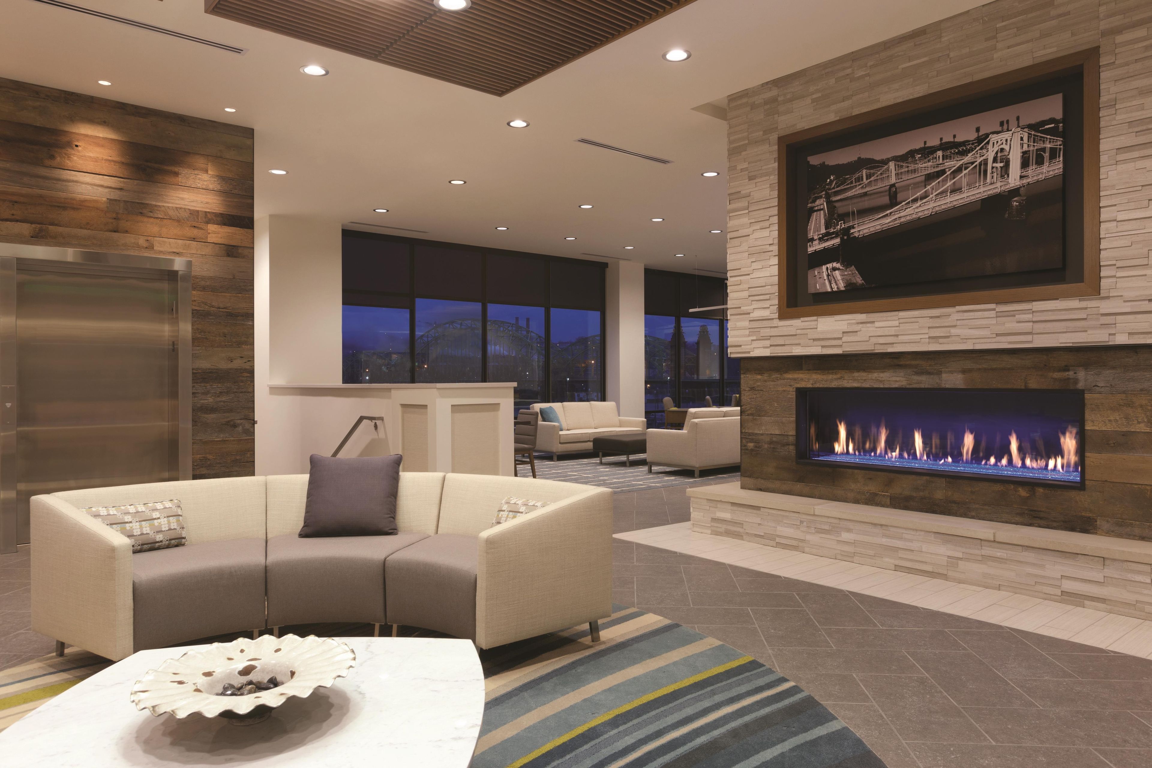 A modern living room with a fireplace, a sofa, and a coffee table.