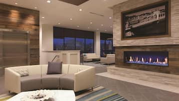 A modern living room with a fireplace, a sofa, and a coffee table.