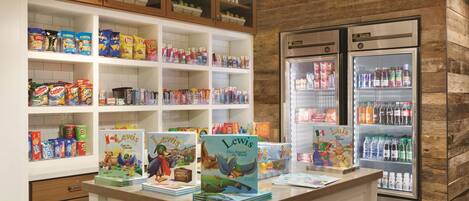 A children's section with snack aisles, a refrigerated display, and a counter with books.