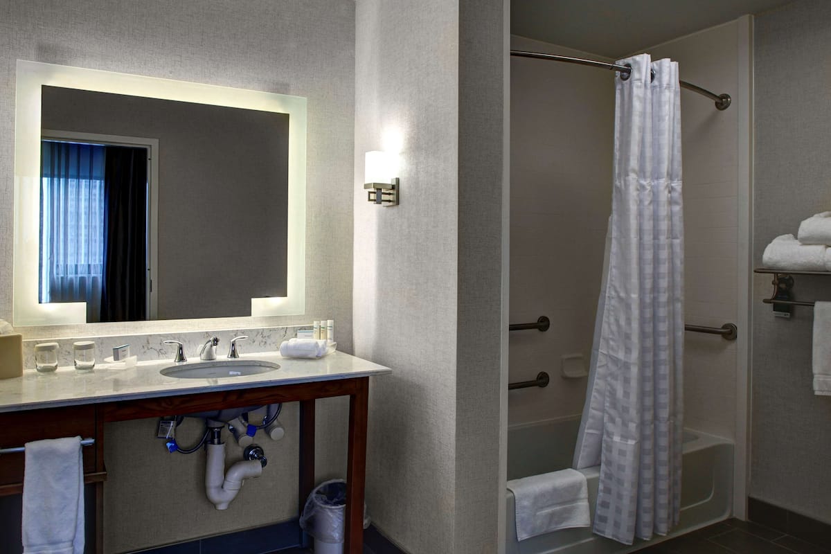 Suite, 1 King Bed, Accessible, Bathtub | Bathroom | Combined shower/tub, deep soaking tub, designer toiletries, hair dryer