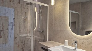 A modern bathroom with a glass-enclosed shower, a sink with a mirror, and a towel dispenser. - Complejo Lago Playa (Formentera)