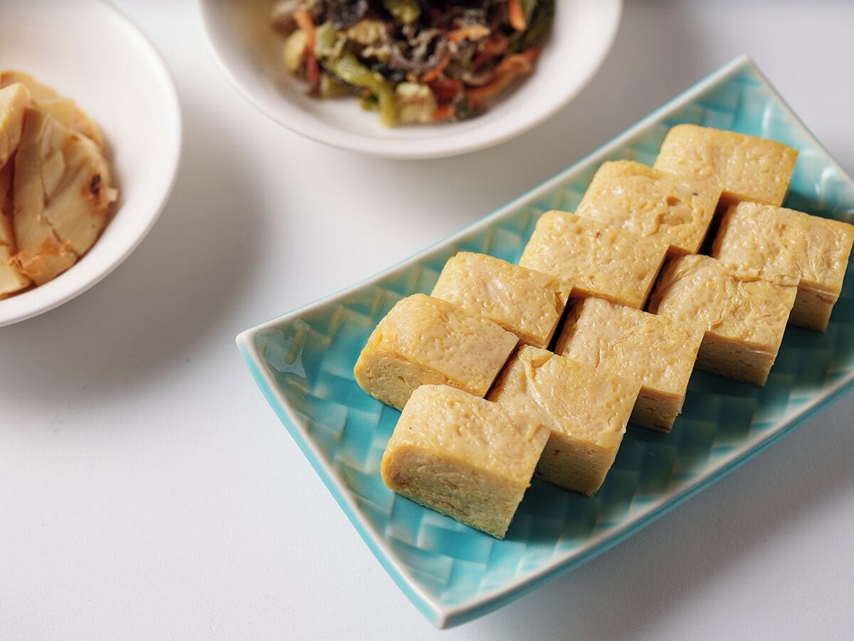 A plate of tofu cubes on a blue and white patterned plate.