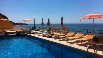 Seasonal outdoor pool, open 9:00 AM to 7:00 PM, pool loungers