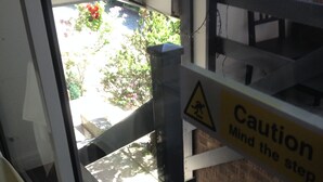 A caution sign with the text "Caution Mind the step" near a staircase. - The New Inn Motel (York)