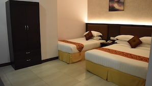 A hotel room with two beds, a wardrobe, and a nightstand. - Sunrise Hotel (Petaling Jaya)