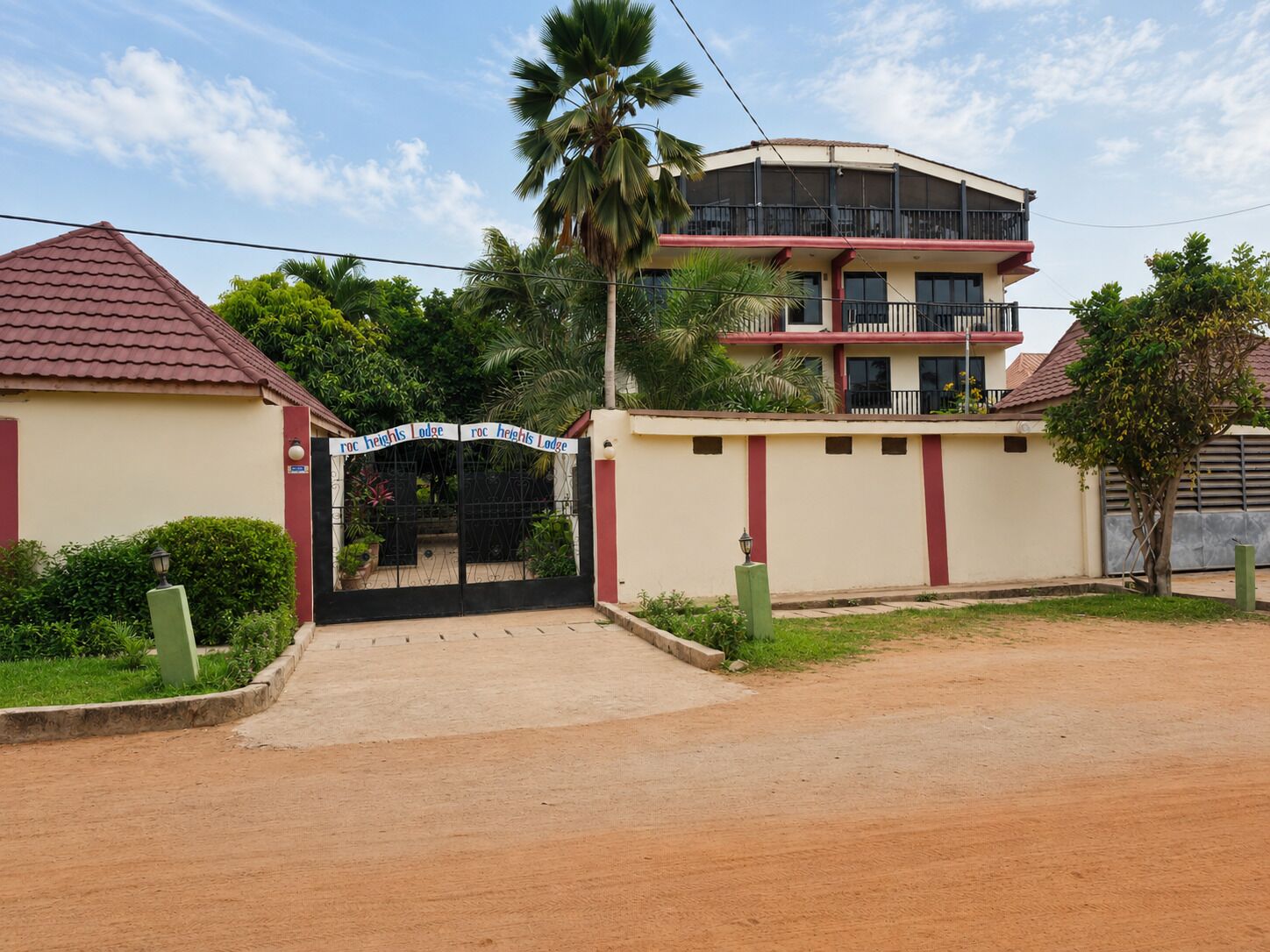 A gated entrance to a building with a sign reading 'Roc Heights Lodge.'
