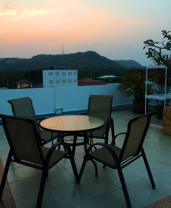 A round table with four chairs on a tiled patio. - Baan Paan Hua Hin (Hua Hin)
