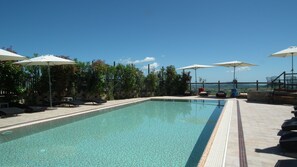 Outdoor pool, an infinity pool, pool loungers