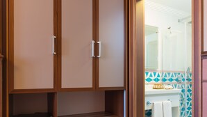A room with a wooden wardrobe, a patterned rug, and a bathroom visible through an open door. - Lalahan (Istanbul)