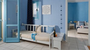 A room with a bed, a bedside table, a window with curtains, a door, and a wall with a decorative pattern. - Piskopiano Village (Hersonissos)