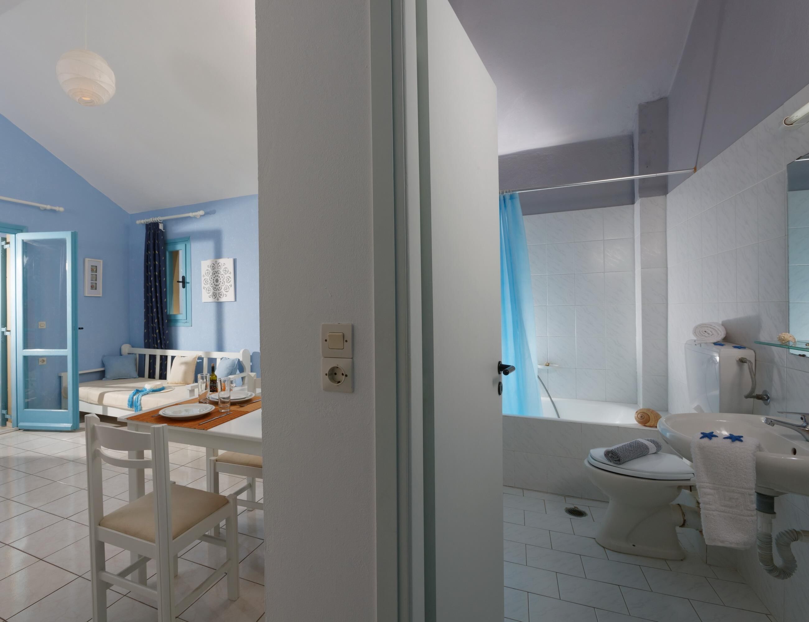 A modern bathroom with a bathtub, toilet, and sink.