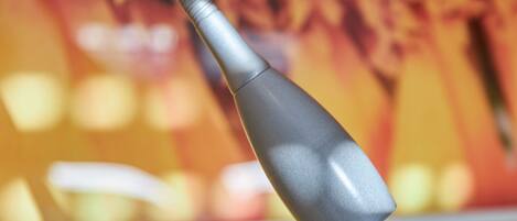 A close-up of a metallic object with a curved handle, possibly a part of a piece of furniture or equipment.