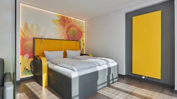 Ein modernes Schlafzimmer mit einem Bett, einem Nachttisch und einem an der Wand montierten Heizkörper.