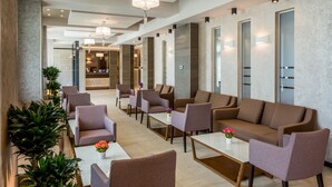 A modern hotel lobby with seating areas, a reception desk, and a spa sign. - New Splendid Hotel & Spa - Adults Only (Constanta)