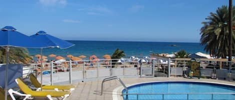 Seasonal outdoor pool, open 10:00 AM to 6:00 PM, pool umbrellas