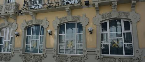 A building with ornate architectural details, including decorative balconies and arched windows.