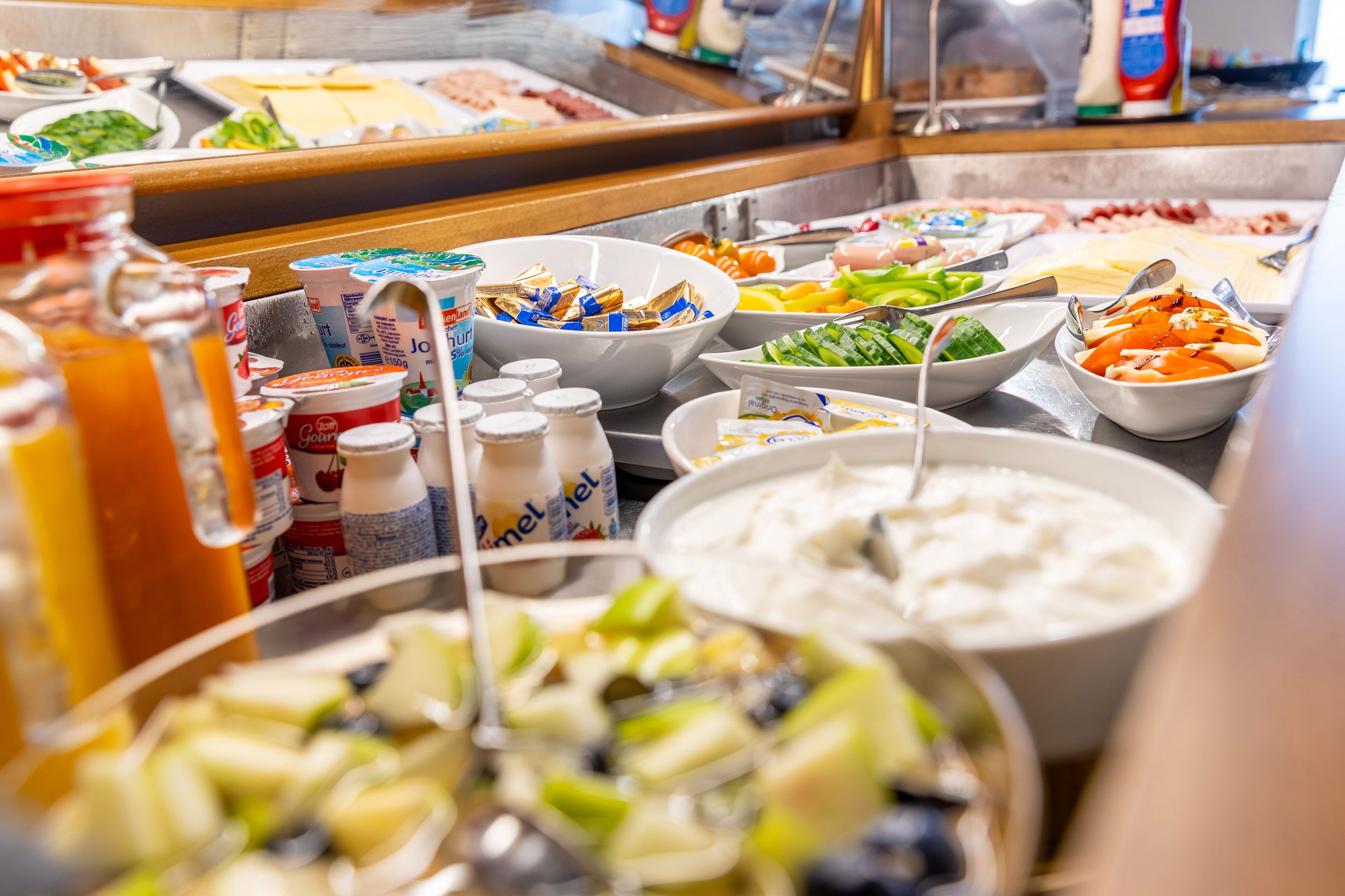 A buffet with various food items and condiments.
