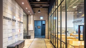 A modern interior with a business center, a restaurant, and a reception area.