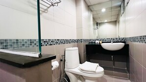 A modern bathroom with a toilet, sink, and shower. - 14 Avenue (Bangkok)