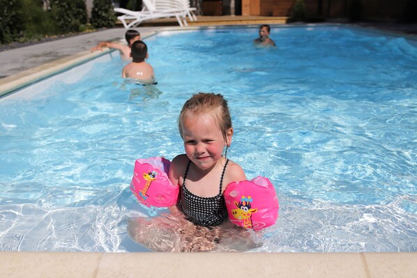 Seasonal outdoor pool, open 9:00 AM to 8:00 PM, pool loungers
