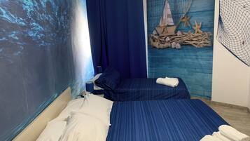 A bedroom with a bed, a nightstand, and a wall mural.