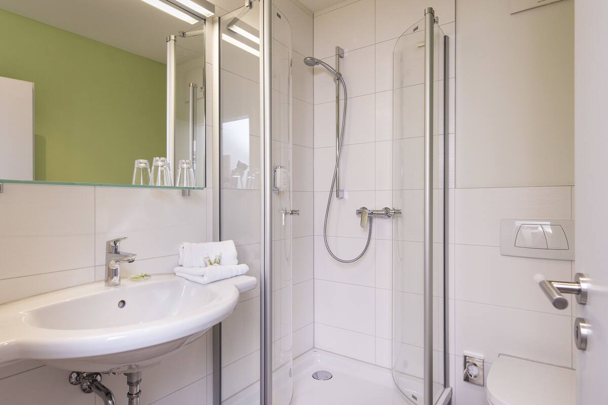 standard double room single use, 1 queen bed | bathroom | shower, free toiletries, hair dryer, towels