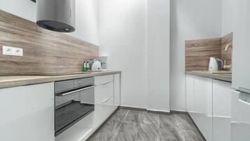 Apartment | Private kitchen | Fridge, stovetop, electric kettle, cookware/dishes/utensils