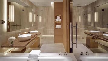 A modern bathroom with two sinks, a large mirror, and a central walk-in shower.
