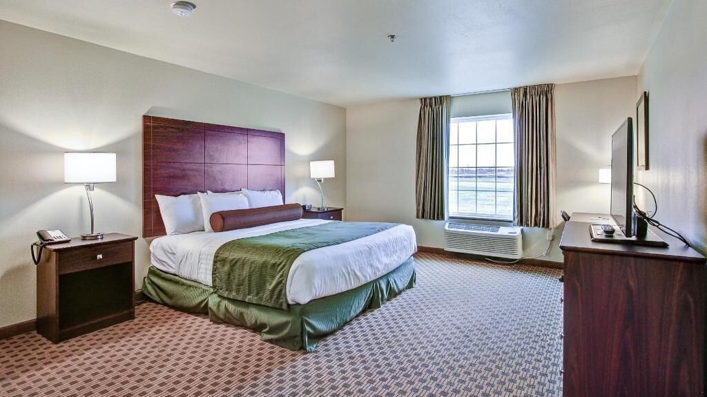 Premium bedding, desk, laptop workspace, blackout drapes