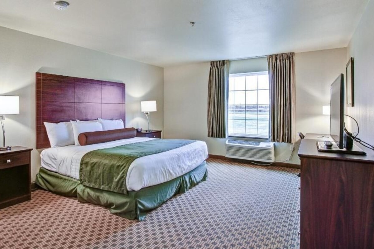 Premium bedding, desk, laptop workspace, blackout drapes