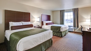Premium bedding, desk, laptop workspace, blackout drapes