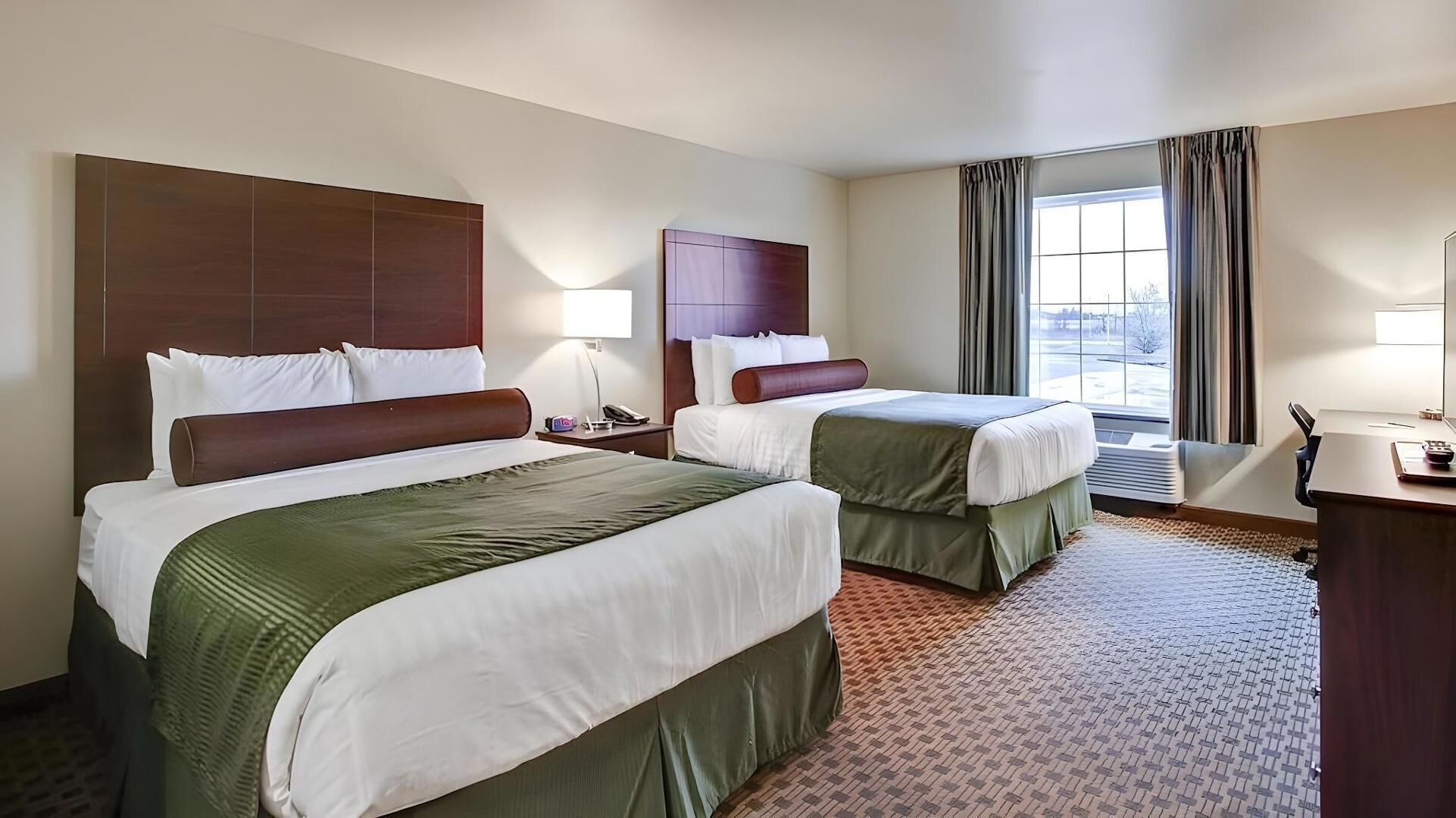 Premium bedding, desk, laptop workspace, blackout drapes