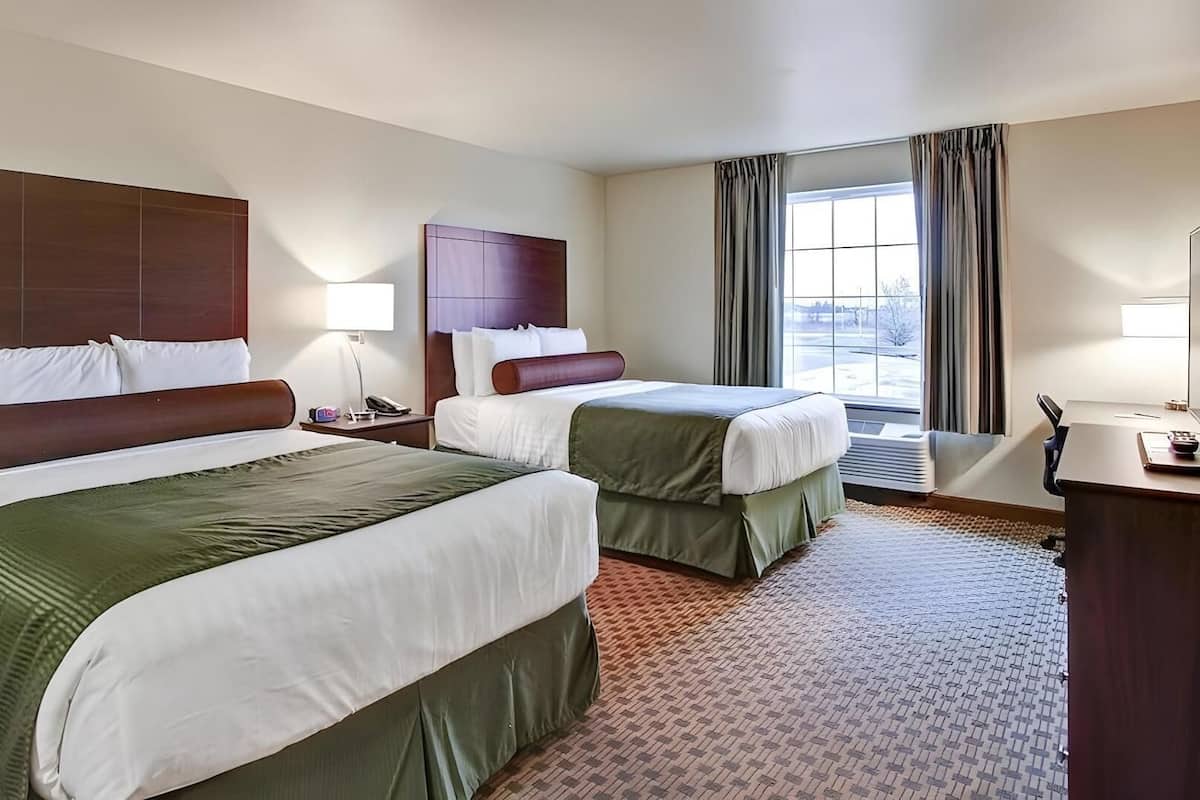Premium bedding, desk, laptop workspace, blackout drapes